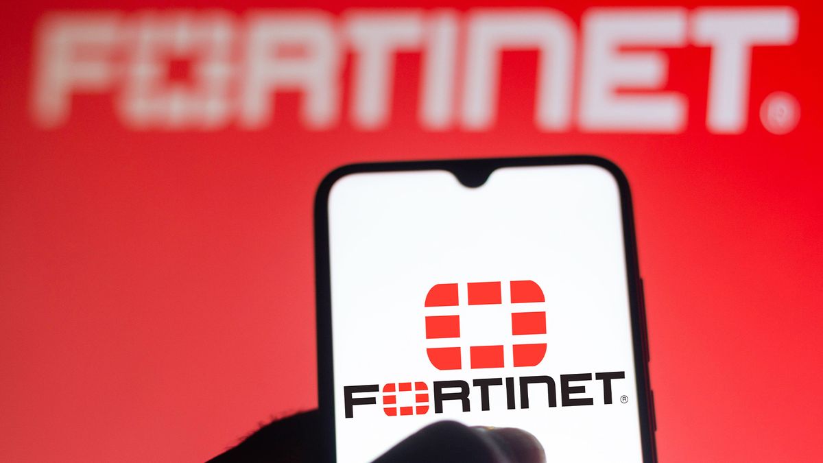 Fortinet logo and branding displayed on a smartphone screen with brand name blurred in background.