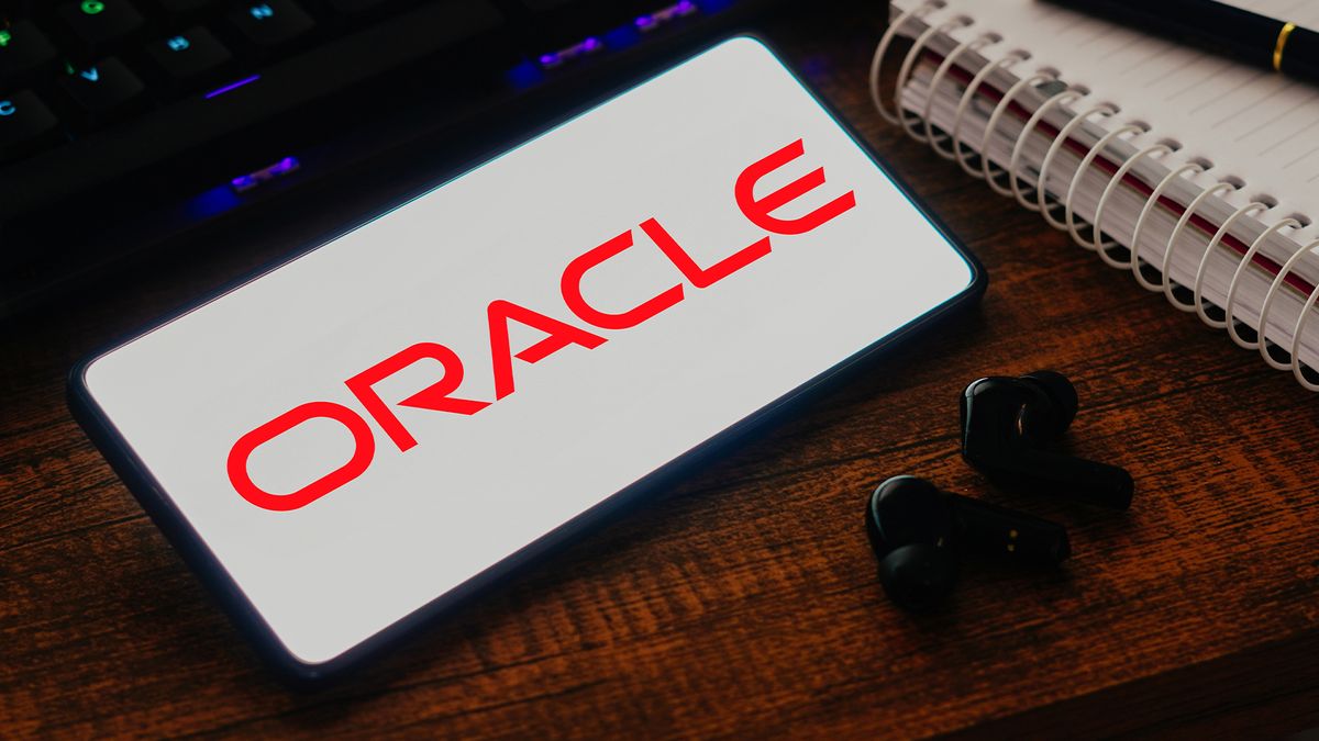 Oracle logo and branding displayed on a smartphone screen sitting on a desk.